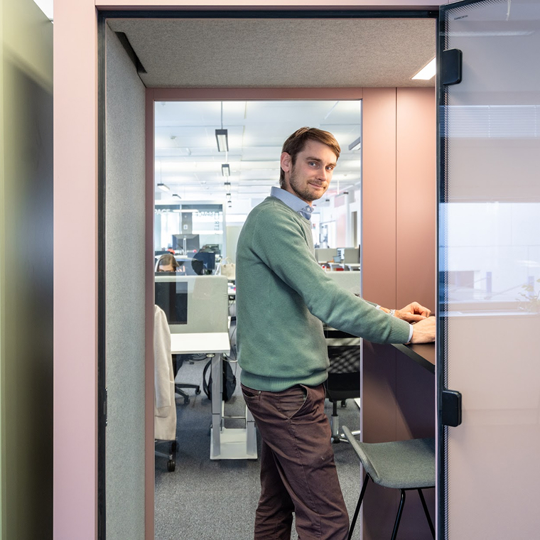 Man working in an Vetrospace one person office pod.